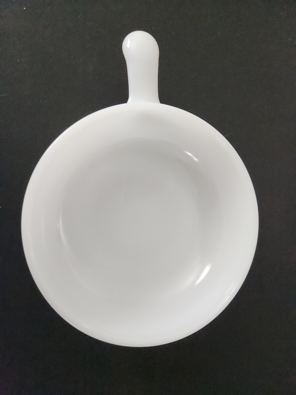 Glasbake white milk glass soup bowl with a single handle.